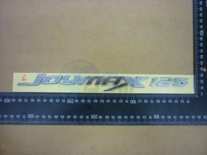 Product image: Sym - 87127-L1E-000 - L. BODY COVER EMBLEM JOYMAX 125 