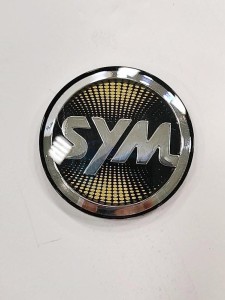 Product image: Sym - 87552-TL1-000-T1 - SYM LOGO ( 50 PC ) TYPE1 ( BK / GD ) 