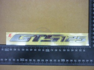 Product image: Sym - 87126-L1A-000 - R. BODY COVER EMBLEM GTS 125 