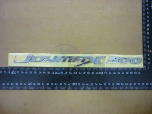 Product image: Sym - 87127-L3C-000 - L. BODY COVER EMBLEM 'JOYMAX 300' 